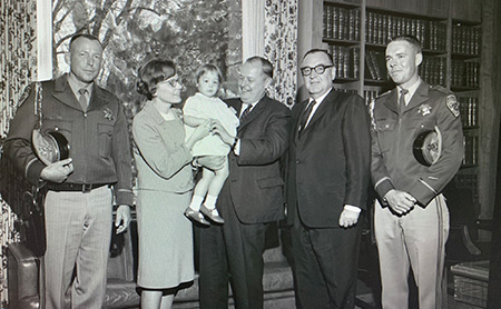 Police officer, Mrs. Champion, their daughter, Director
                      Champion, Governor Edmund Brown Sr., police officer.